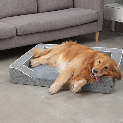 Dog lying on a gray pet bed in a living room.