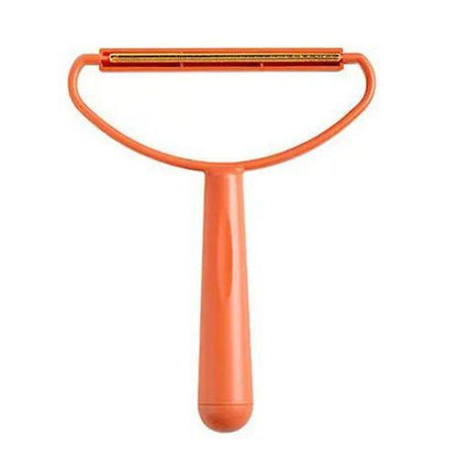 Orange pet grooming brush on a white background